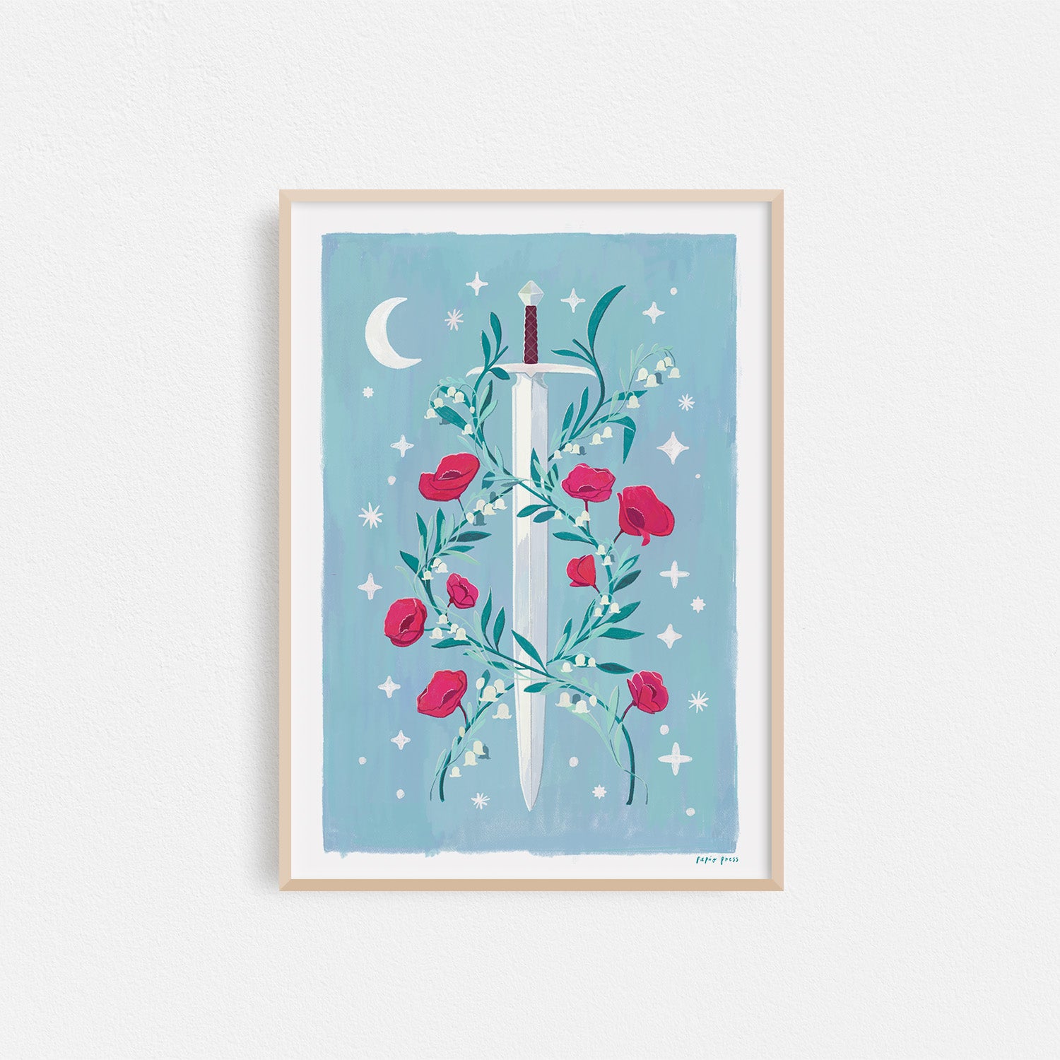 The Floral Sword Artists Print by Papio Press features a silver sword with red roses and green leaves on a blue background with a crescent moon and stars, printed as an inkjet print on 100% cotton paper for vivid, archival quality.