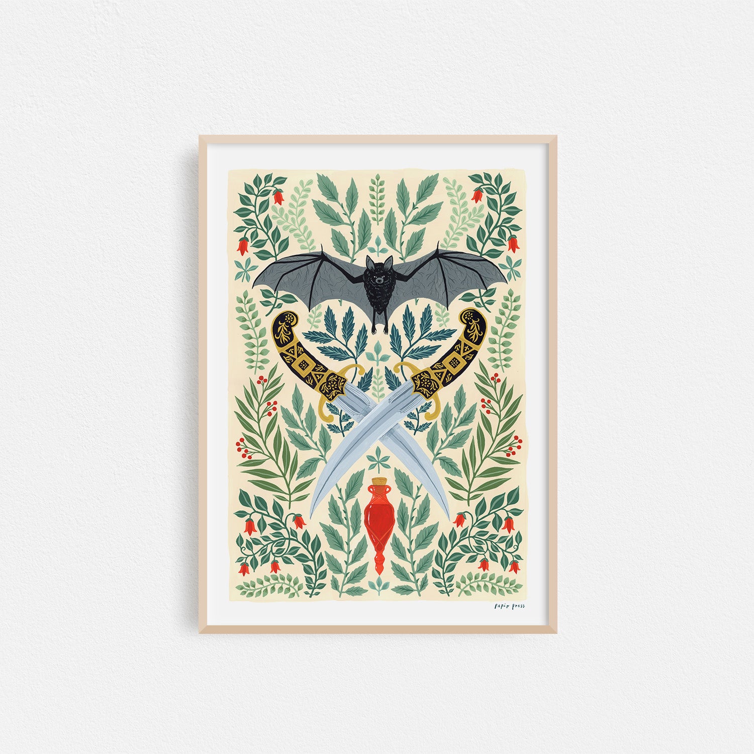 The Weapons & Wings Artists Print by Papio Press is a framed archival quality artwork featuring a black bat with wings spread above two ornate swords and a red dagger, surrounded by green leaves and red berries on a light background.