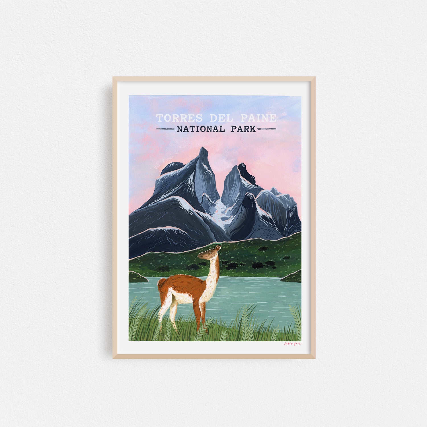 The Torres Del Paine National Park Artists Print by Papio Press features a guanaco by a tranquil lake, dramatic mountains, and a pink-blue sky—beautifully reproduced as an archival inkjet print.