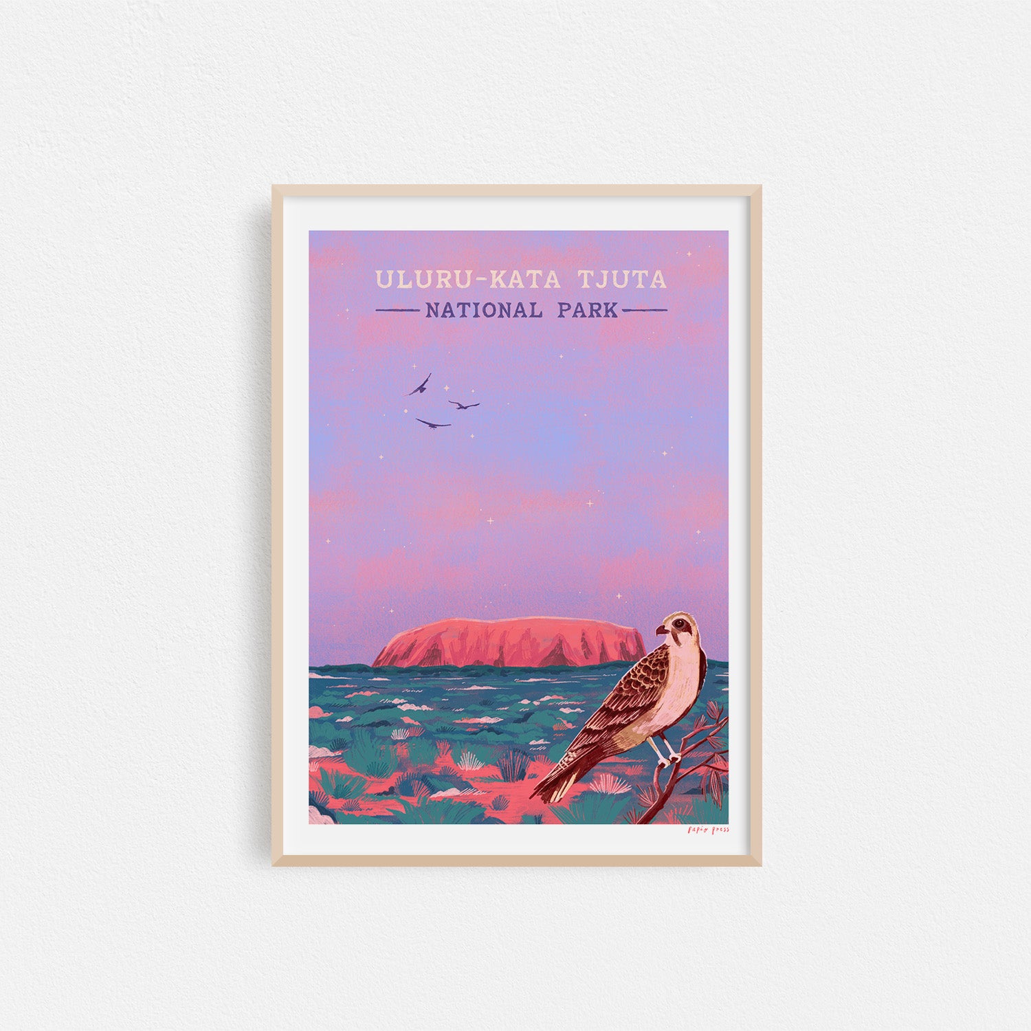 Uluru National Park Artists Print by Papio Press features a stylized sunset scene with pink sky, distant rock formations, and birds on archival satin paper.