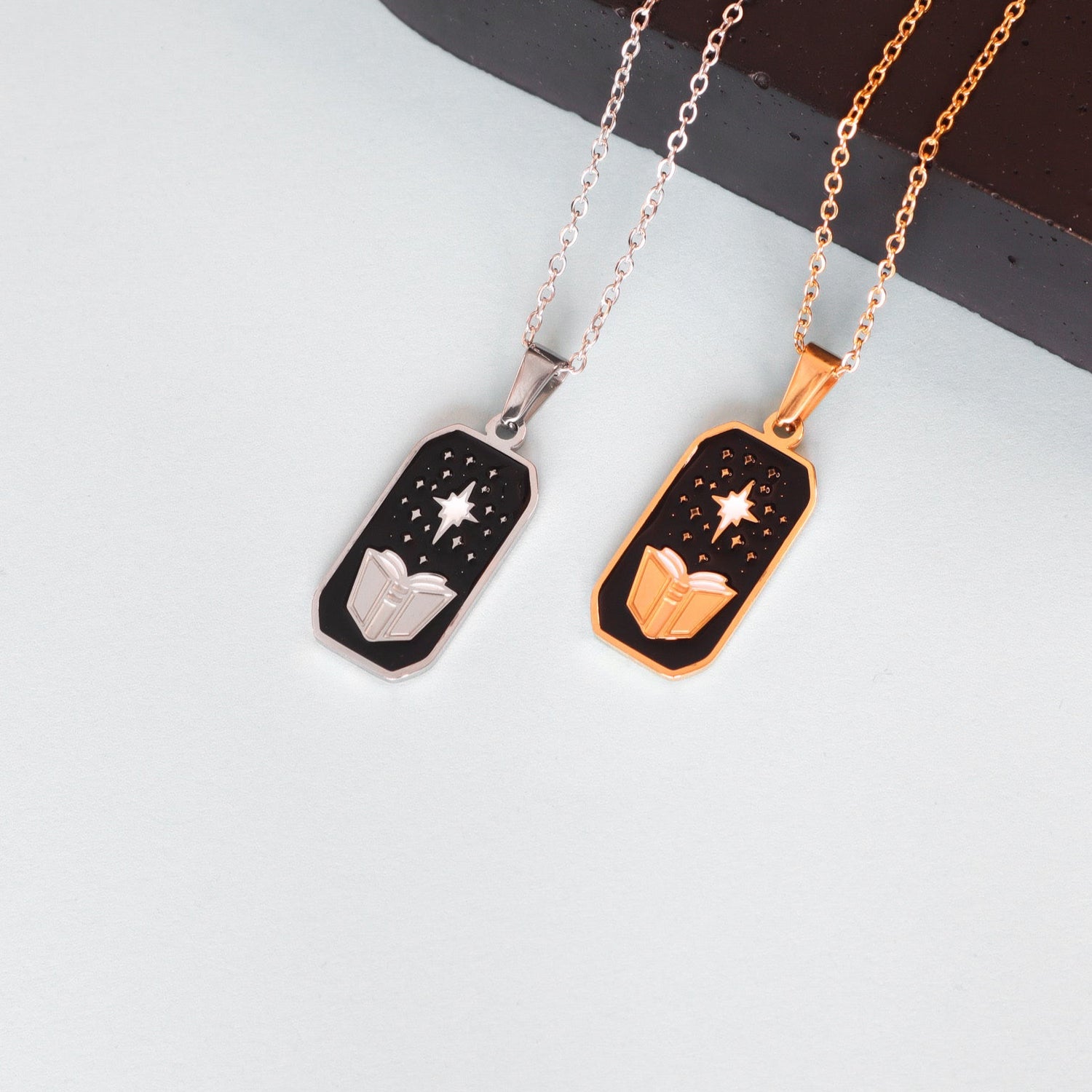 Papio Press’s The Sorcerer Pendant Enamel Necklace comes in silver or gold, with a black background, engraved star, dots, and geometric design—an enchanting piece perfect for fantasy jewelry lovers.