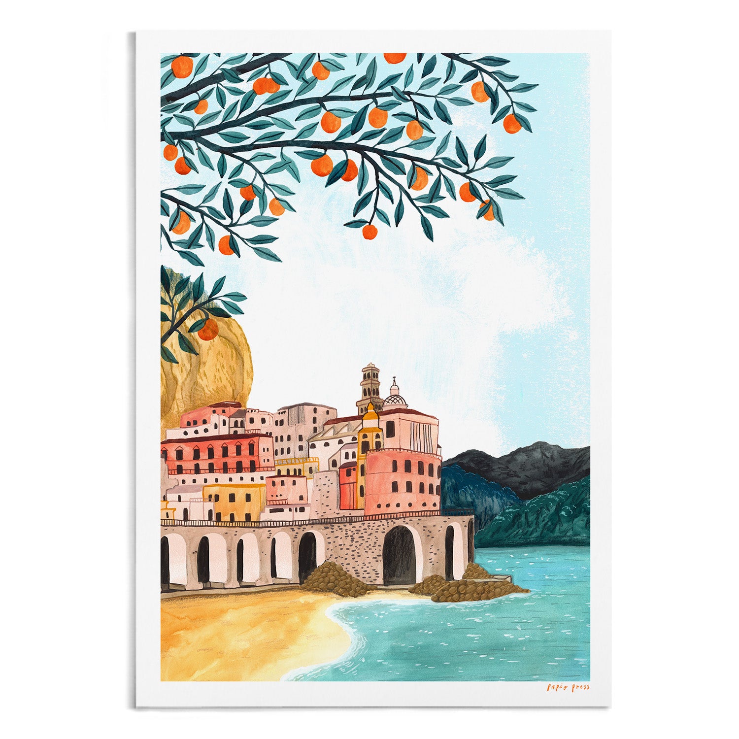 The Amalfi Coast Artists Print by Papio Press features a vibrant illustration of pastel Mediterranean village buildings, a sandy beach, blue water, distant mountains, and an orange tree branch—ideal as an archival paper inkjet print.