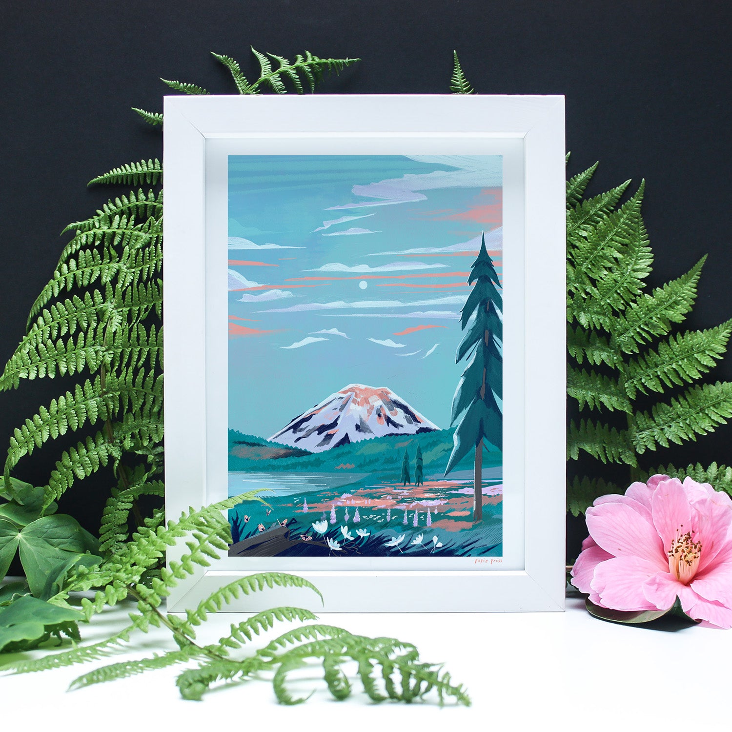 The Mt. Rainier National Park Artists Print by Papio Press features a snowy mountain, pine tree, and lake framed by green ferns, with a pink hibiscus on the right, all printed on archival satin paper against a black background.