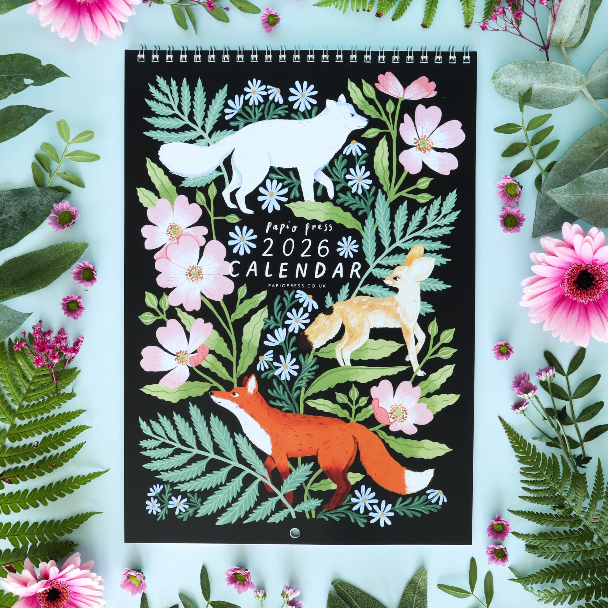 The Gift Set of Two 2026 Calendars by Papio Press features charming illustrations of foxes  and pink flowers with green leaves, all presented in a whimsical style perfect for adding charm to any space.