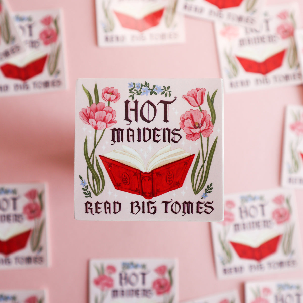 A square sticker featuring a red book with the text 'Hot Maidens Read Big Tomes'.