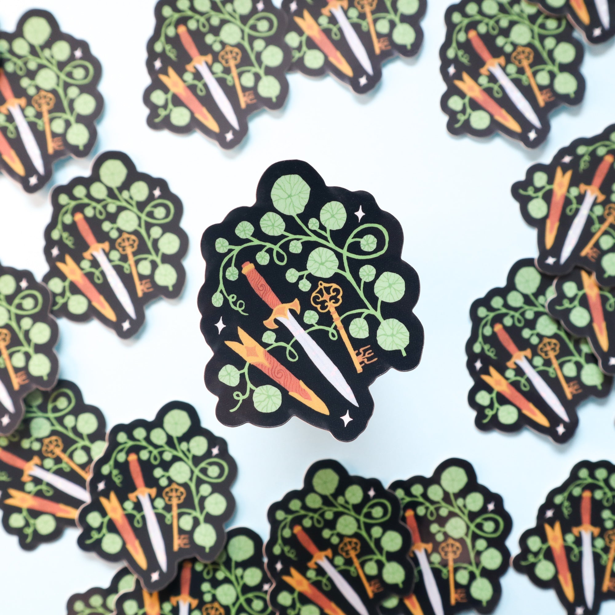 The Rogue Sticker by Papio Press features illustrated vinyl stickers of leafy green plants with carrots in orange, yellow, and white hues on a glossy light background.