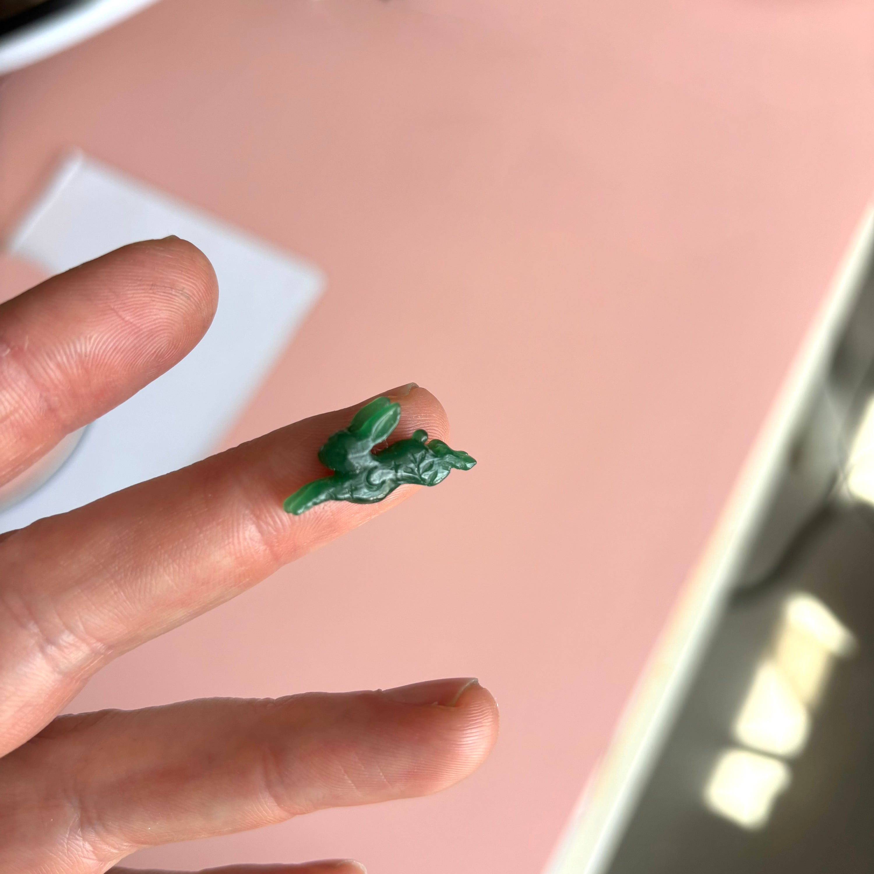 A green rabbit carved out of wax. 