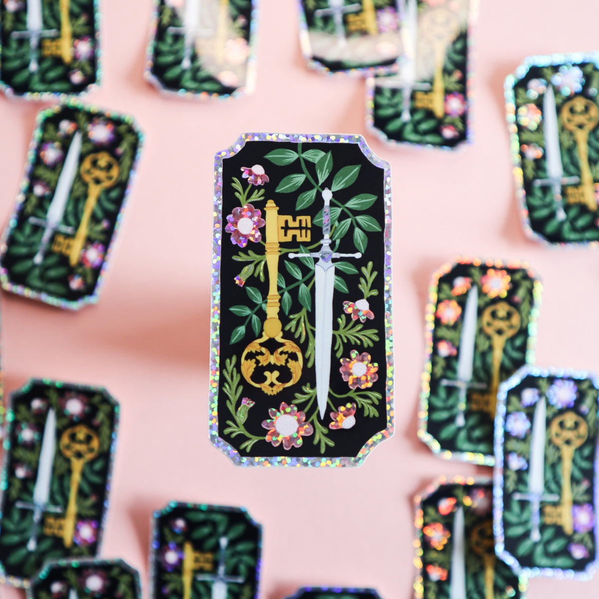 A glitter sticker featuring a dagger and a key.