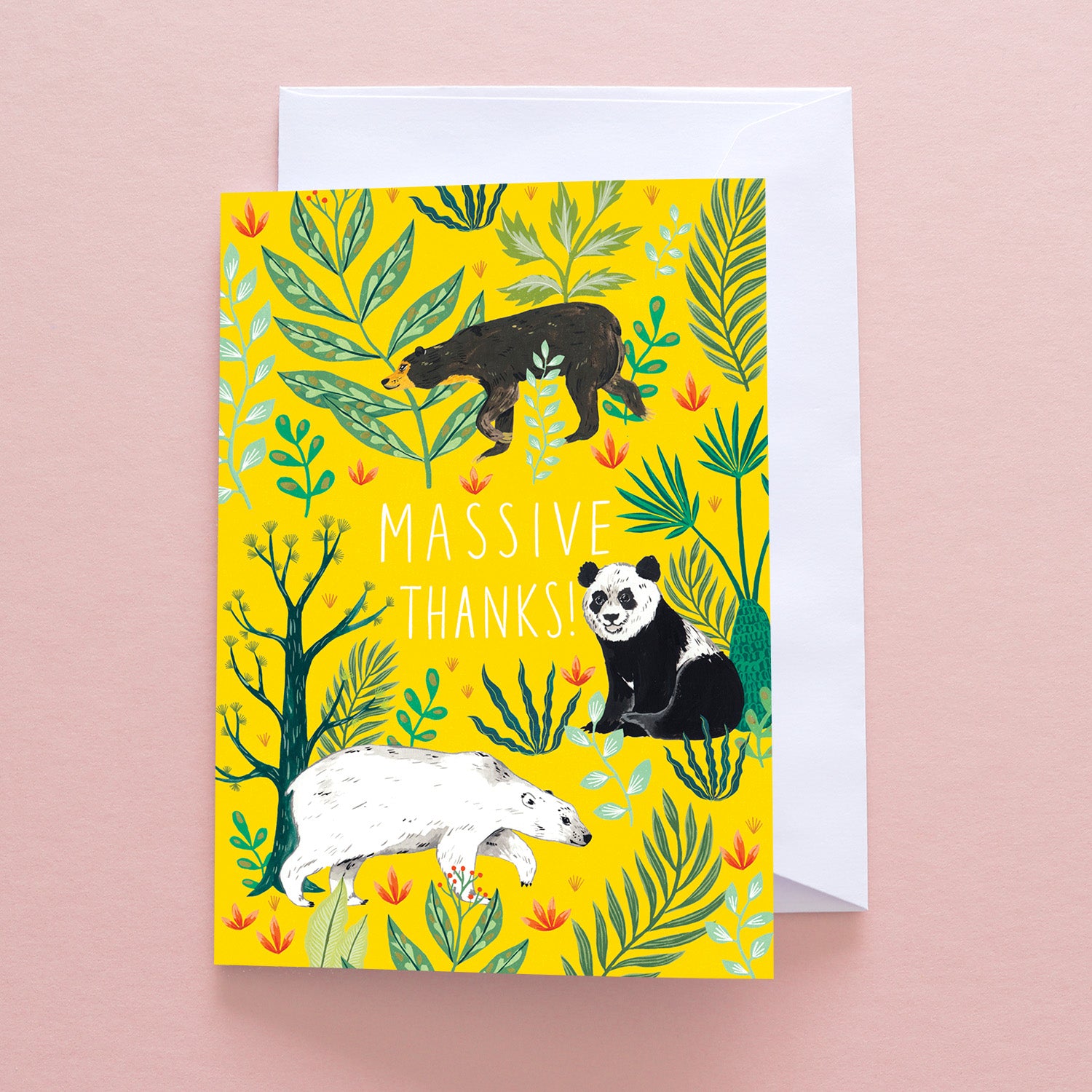 The Massive Thanks Greetings Card by Papio Press features MASSIVE THANKS! in white, with a panda, anteater, and bear amid green leaves on a yellow background. Printed on recycled stock and shown on a pale pink surface.