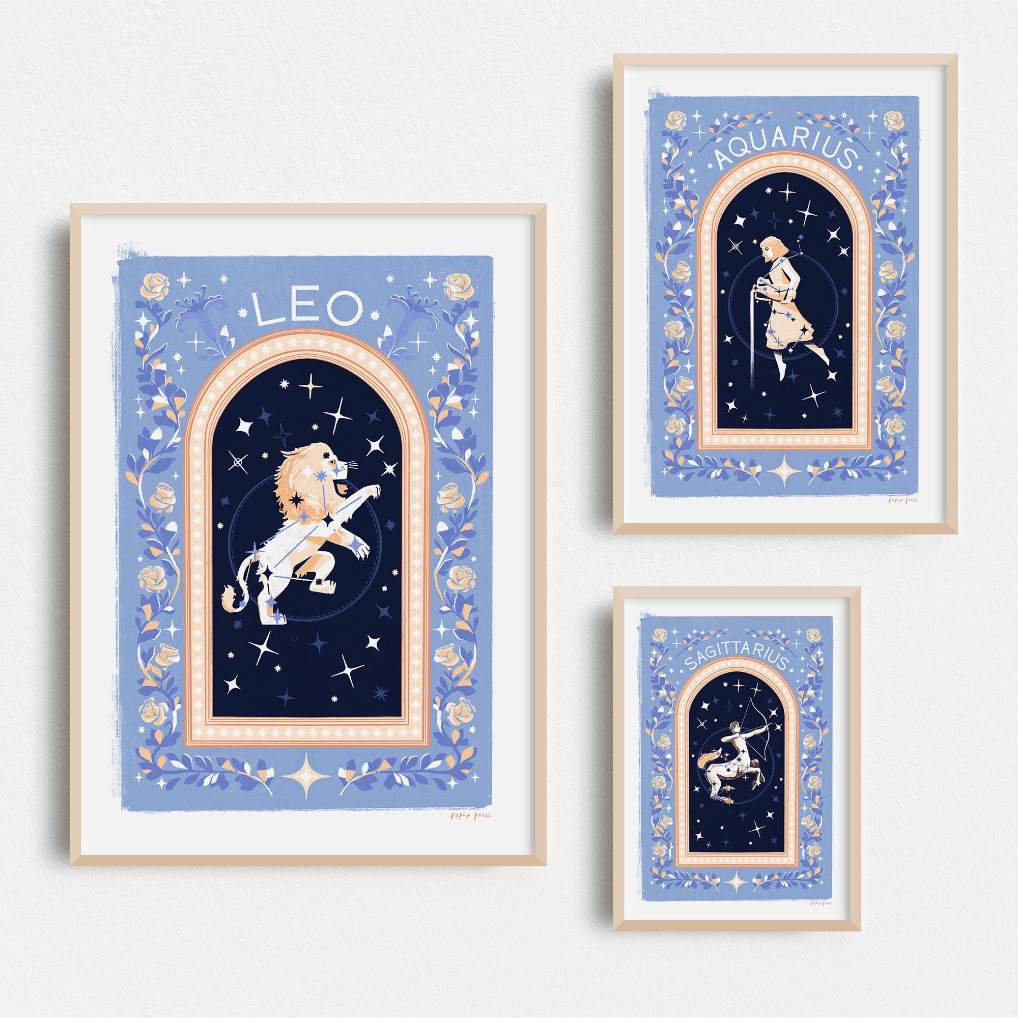 Papio Presss Choose your own Constellation Print // Star Signs features zodiac art on archival satin paper, each print showing a star sign in a blue, floral and celestial frame, beautifully displayed on a white wall.