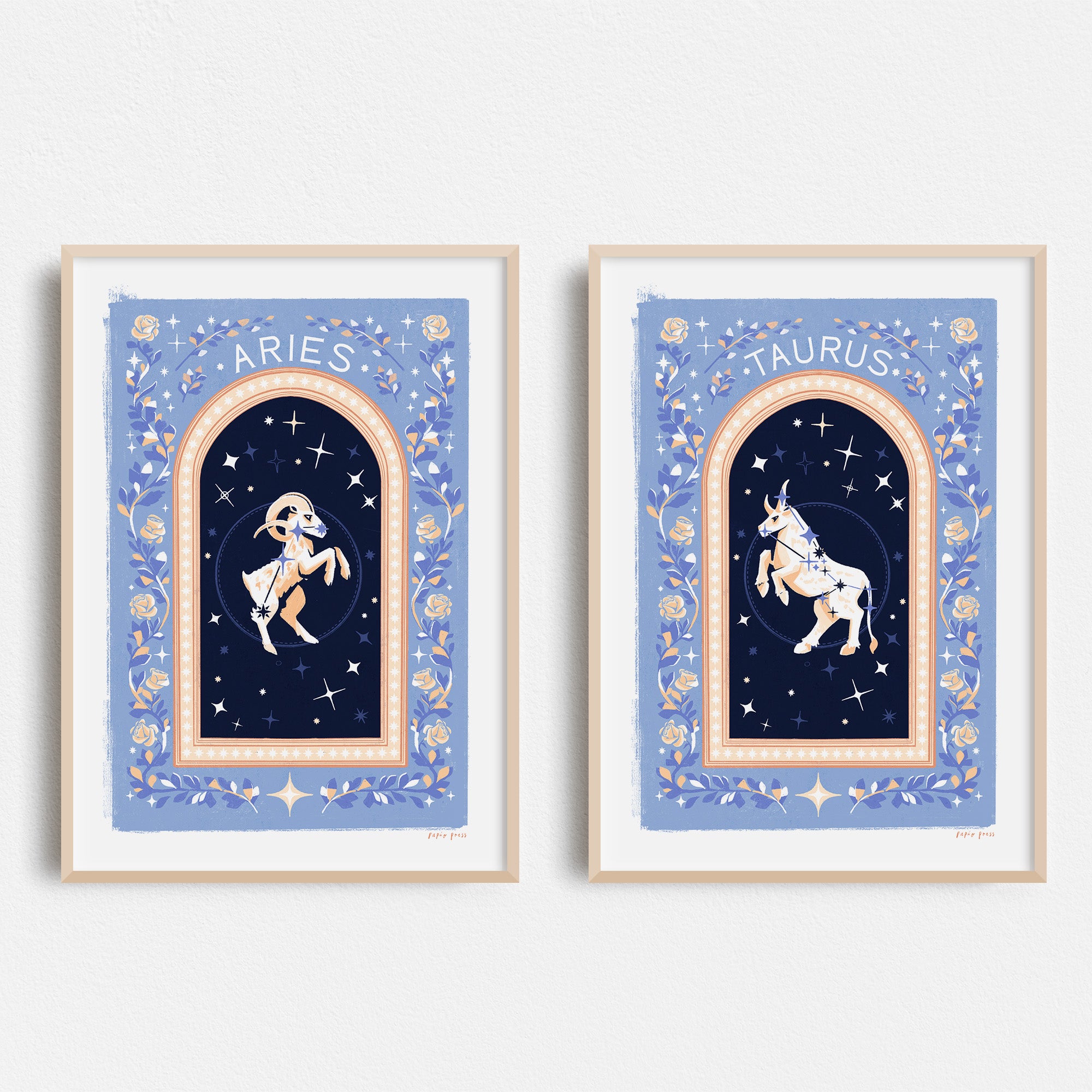 Two Papio Press Choose your own Constellation Print // Star Signs framed art prints, Aries (dancing ram) and Taurus (standing bull), feature blue floral borders and starry night backgrounds on archival satin paper.